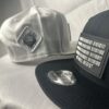 Image featuring a black Slash-32 9/50 Snapback hat with a black binary patch and a white fitted hat with a white diamond patch, both showcasing the /32 microchip emblem.