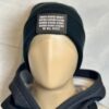 Image of the black “We Will Resist” rolled beanie by Slash-32 on a mannequin wearing a hoodie, featuring a grey rectangle patch with binary matrix and “We Will Resist” text.