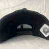 Direct back view of the Slash-32 9/50 Snapback hat, Black (Panda Mode) "We Will Resist" cap, highlighting the white diamond-shaped /32 microchip patch stitched in.