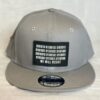 Image of Slash-32 9/50 Snapback hat, Grey "We Will Resist" cap, featuring a front black rectangle patch with a binary matrix above the “We Will Resist” text.