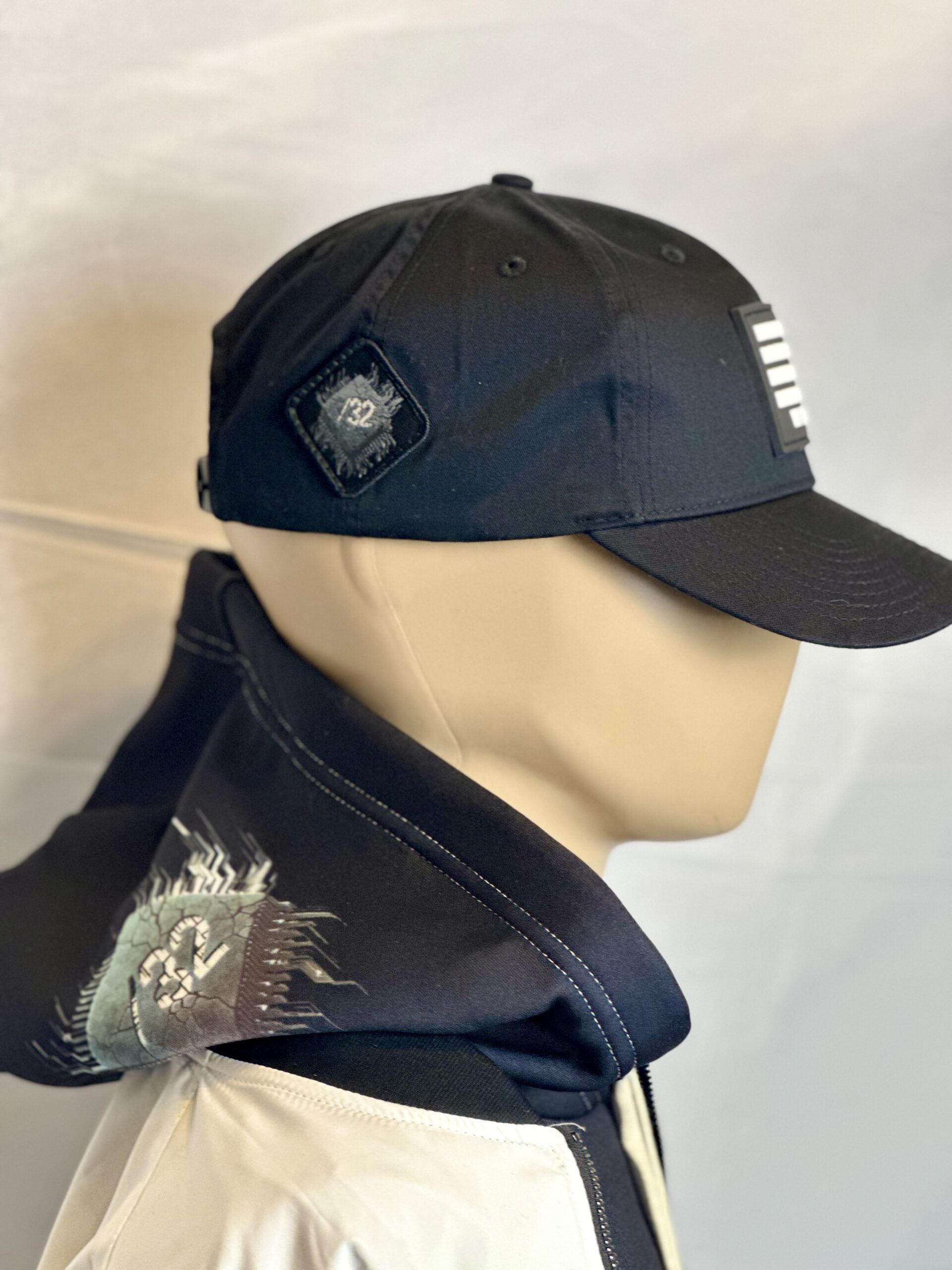 Image of Slash-32 Ladies Snug Black "We Will Resist" Snapback Cap on mannequin, featuring binary code and “We Will Resist” text on the front panel, with the /32 microchip patch sewn on the side.