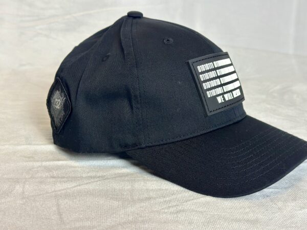 Image of Slash-32 Ladies Snug Black "We Will Resist" Snapback Cap, side view showing the /32 microchip patch and binary design with “We Will Resist” text across the front.