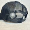 Close-up image of the back of the Slash-32 Trucker Style Snapback hat - Black "We Will Resist" cap, highlighting the diamond-shaped /32 microchip patch on the side.