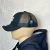 Image of Slash-32 Trucker Style Snapback hat - Black "We Will Resist" cap, side view showing the black diamond-shaped /32 microchip patch and partial view of the front binary patch.