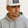 Image of a known host wearing the Slash-32 9/50 Snapback White cap featuring the black rectangular patch with binary code and “We Will Resist” text.
