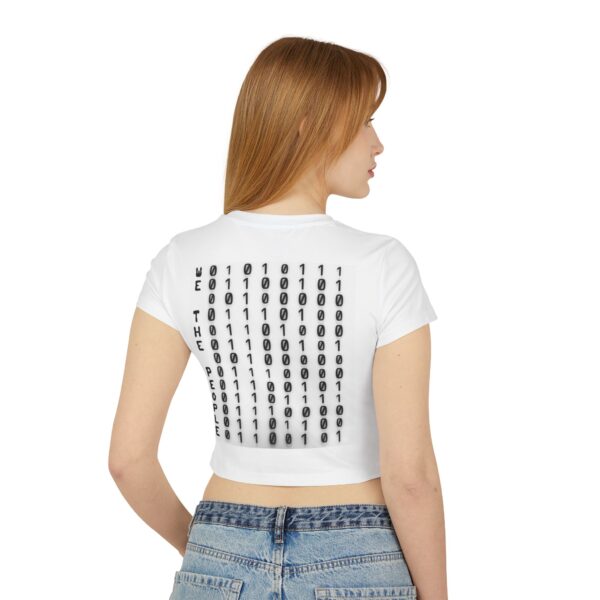 Back view of female model wearing the white ‘We The People’ Ladies Baby Tee from Slash-32’s Preamble Collection. Features bold back text reading “We The People” next to a cascading binary matrix, symbolizing digital unity and collective identity in the tech age.