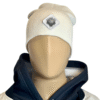 Image of white slouch style fitted beanie on mannequin with diamond-shaped white patch featuring microchip symbol and “/32” text, sewn onto front of hat.