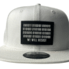 Image of Slash-32 9/50 Snapback hat, White showing the black rectangular patch embroidered with binary code and “We Will Resist” text on the front.