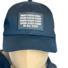 Image of Slash-32 Trucker Style Snapback hat - Black "We Will Resist" cap on mannequin, featuring a black rectangle patch with binary matrix and “We Will Resist” text on the front.