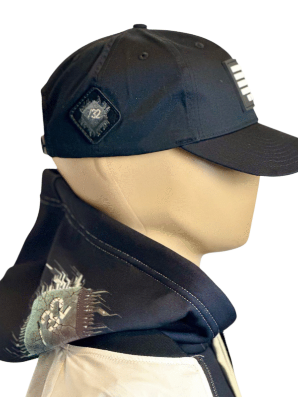 Image of Slash-32 Ladies Snug Black "We Will Resist" Snapback Cap on mannequin, featuring binary code and “We Will Resist” text on the front panel, with the /32 microchip patch sewn on the side.
