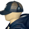 Image of Slash-32 Trucker Style Snapback hat - Black "We Will Resist" cap, side view showing the black diamond-shaped /32 microchip patch and partial view of the front binary patch.