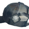 Close-up image of the back of the Slash-32 Trucker Style Snapback hat - Black "We Will Resist" cap, highlighting the diamond-shaped /32 microchip patch on the side.