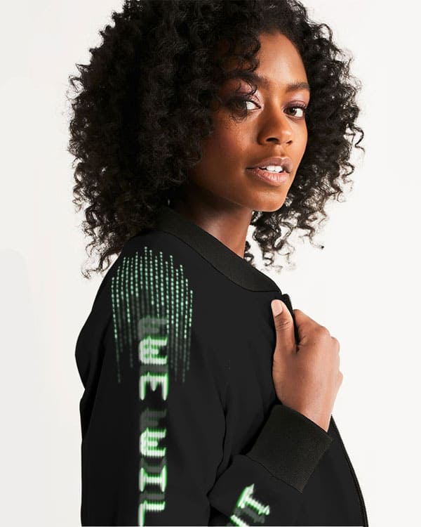 Side view of a female model wearing a black bomber jacket with “We Will Fight” text and binary code visible on the sleeve.