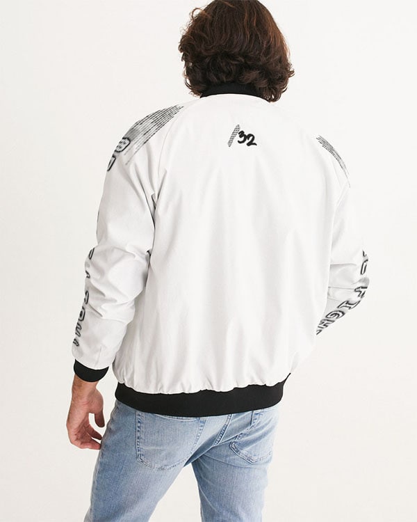 Back view of a male model wearing a white bomber jacket with black accents, showing the “/32” logo centered on the upper back and “We Will Fight” text running down both sleeves.